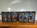 Six Lucky Bustar Magic Number treat bags, three cat and three dog chicken-flavored pouches, displayed on a wooden shelf